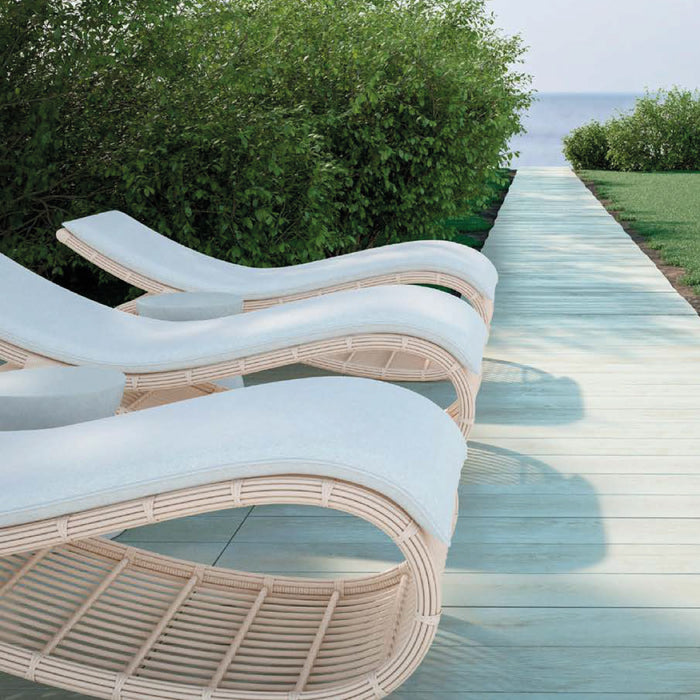 Modern style luxurious beige chaise lounge beside the pool.