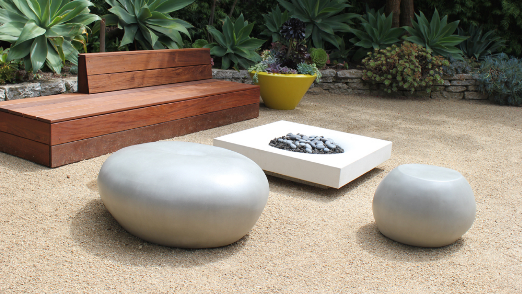 Boxhill's garden pebble seat and table are the perfect blend of form and function in this zen patio space. 