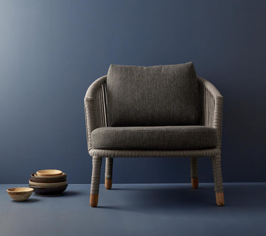 Boxhill's Moments Outdoor Lounge Chair lifestyle image with pile of bowls at the side
