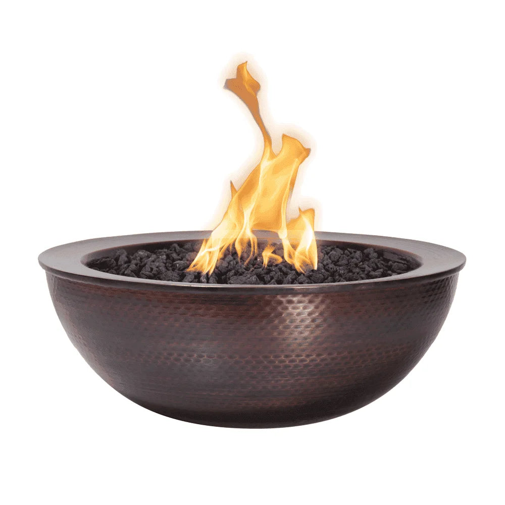 Dark brown round outdoor copper fire bowl filled with lava rocks with flames on top