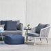Boxhill's Moments Outdoor Lounge Chair lifestyle image with Moments 3-Seater sofa and a fabric footstool at patio
