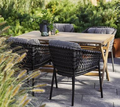 Boxhill's Ocean Outdoor Dining Armchair lifestyle image with teak table at patio