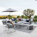 Boxhill's Horizon 2-Seater Outdoor Right Module Sofa lifestyle image together with Horizon 2-Seater Outdoor Left Module Sofa beside the pool with a man and a woman sitting down having a chat and a parasol behind