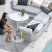 Boxhill's Horizon 2-Seater Outdoor Left Module Sofa lifestyle image together with Horizon 2-Seater Outdoor Right Module Sofa at patio with a white round table and a woman sitting down holding a glass of water