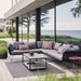 Boxhill's Horizon 2-Seater Outdoor Left Module Sofa lifestyle image together with Horizon 2-Seater Outdoor Right Module Sofa beside glass wall at patio, with rectangular table at the center and a small round side table at the side