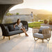 Boxhill's Nest Lounge Chair Lifestyle image at patio with a woman sitting on a 2-seater sofa