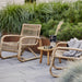 Boxhill's Curve Lounge Weave Outdoor Chair Natural lifestyle image with side table at patio