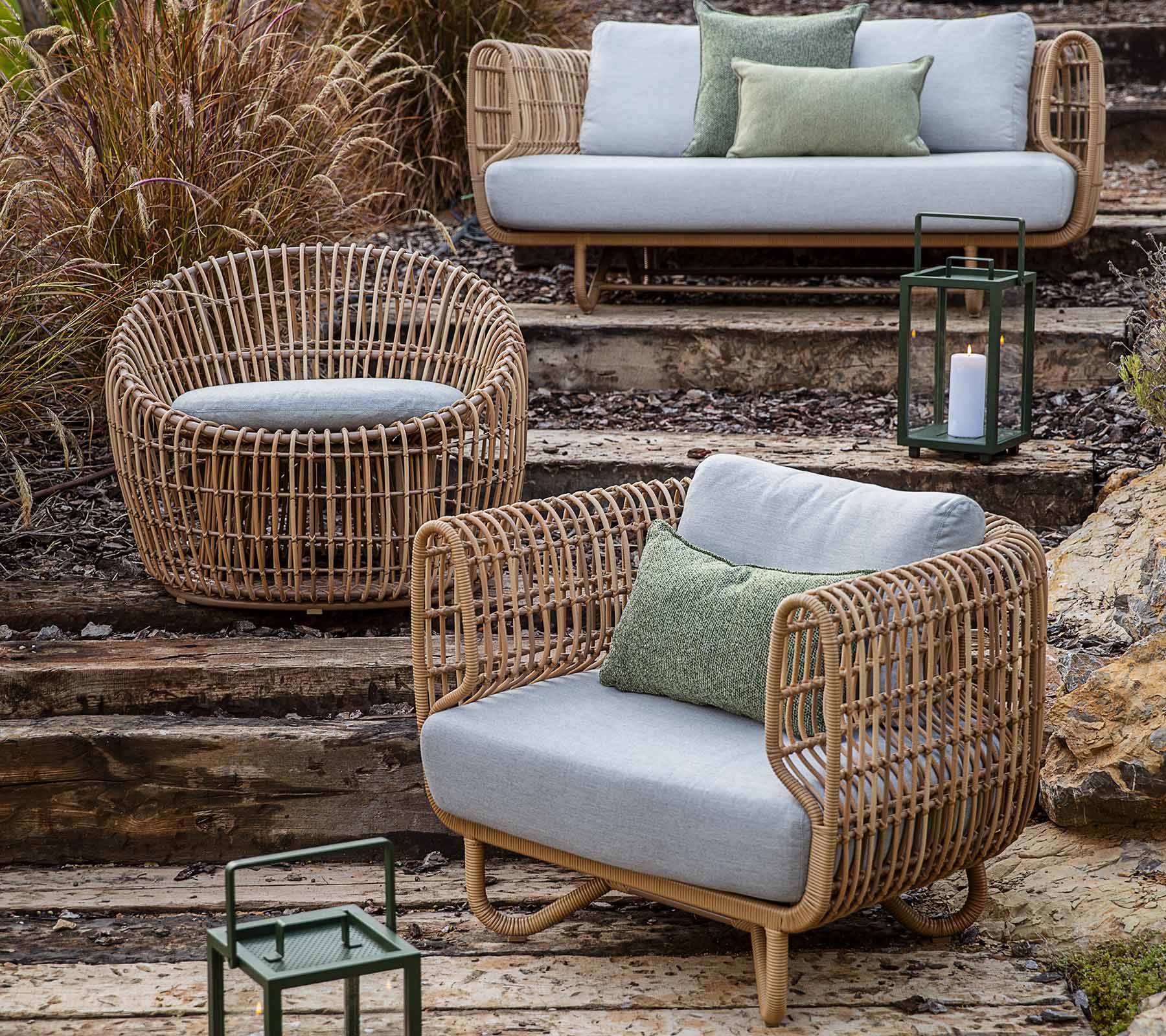 Boxhill's Nest 2-Seater Sofa lifestyle image with Nest Lounge Chair, Nest Round Rattan Chair and lighthouse Lantern on the stairs