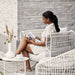 Boxhill's Nest Lounge Chair Lifestyle image with a woman sitting and reading a magazine