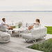 Boxhill's Nest Sofa Outdoor 3 Seater lifestyle image at patio with man and a woman sitting down having a chat