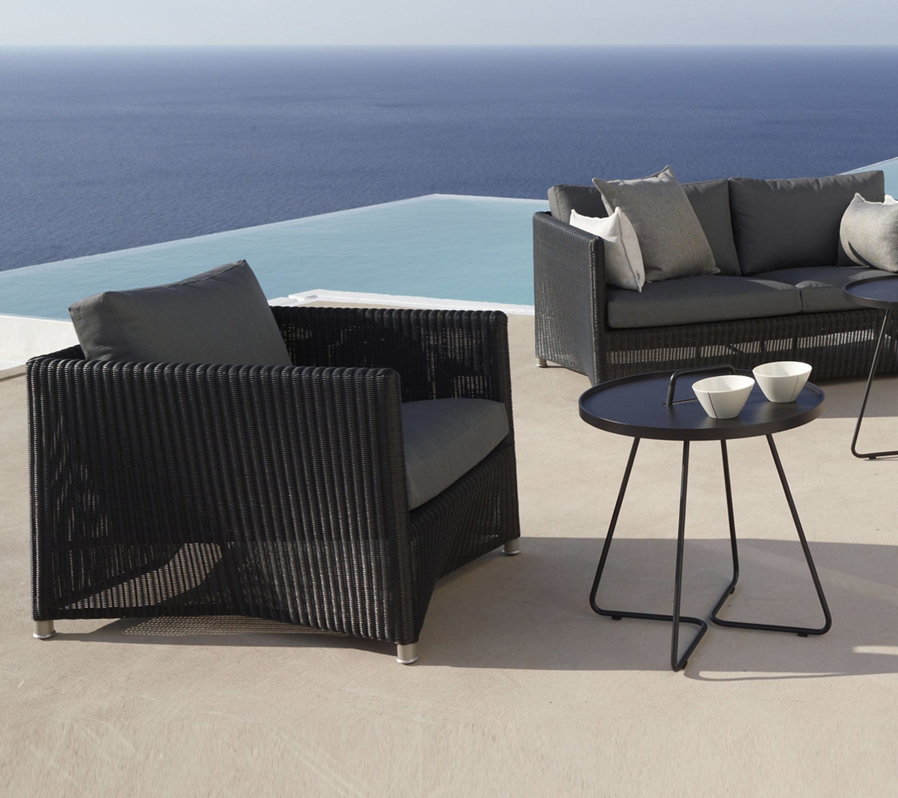 Boxhill's Diamond Weave Lounge Chair lifestyle image with Diamond 2-Seater Weave Sofa and side table beside the pool