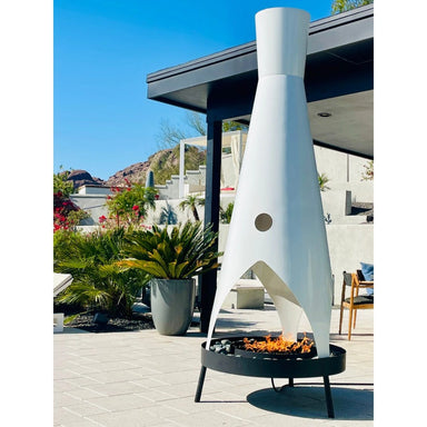 Tall unique outdoor metal fire pit with a sleek design placed on a patio