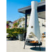 Tall unique outdoor metal fire pit with a sleek design placed on a patio