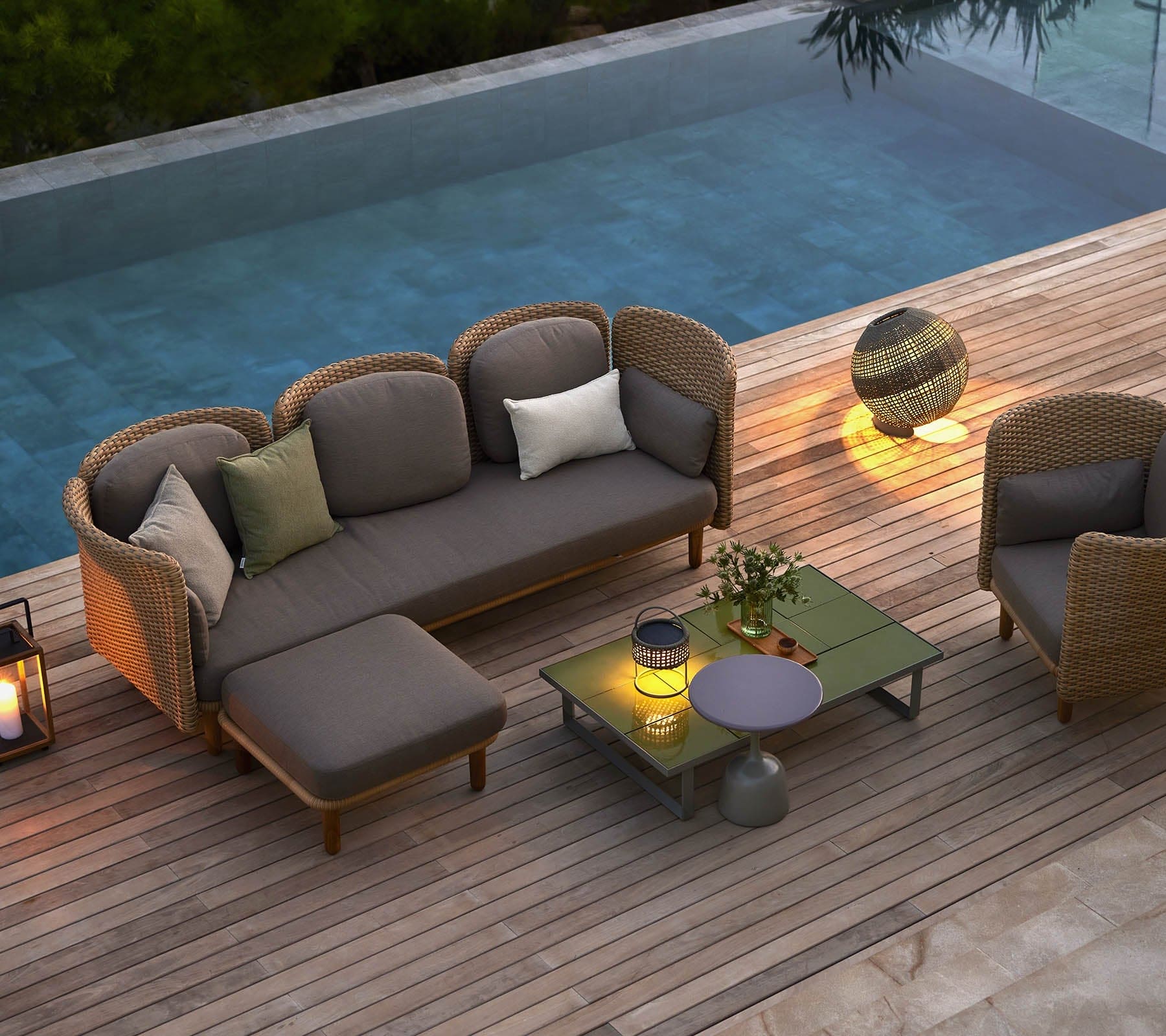Boxhill's Glaze Outdoor Rectangular Coffee Table lifestyle image with 3 seater sofa, single module sofa and lounge chair on wooden platform poolside