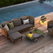 Boxhill's Glaze Outdoor Rectangular Coffee Table lifestyle image with 3 seater sofa, single module sofa and lounge chair on wooden platform poolside