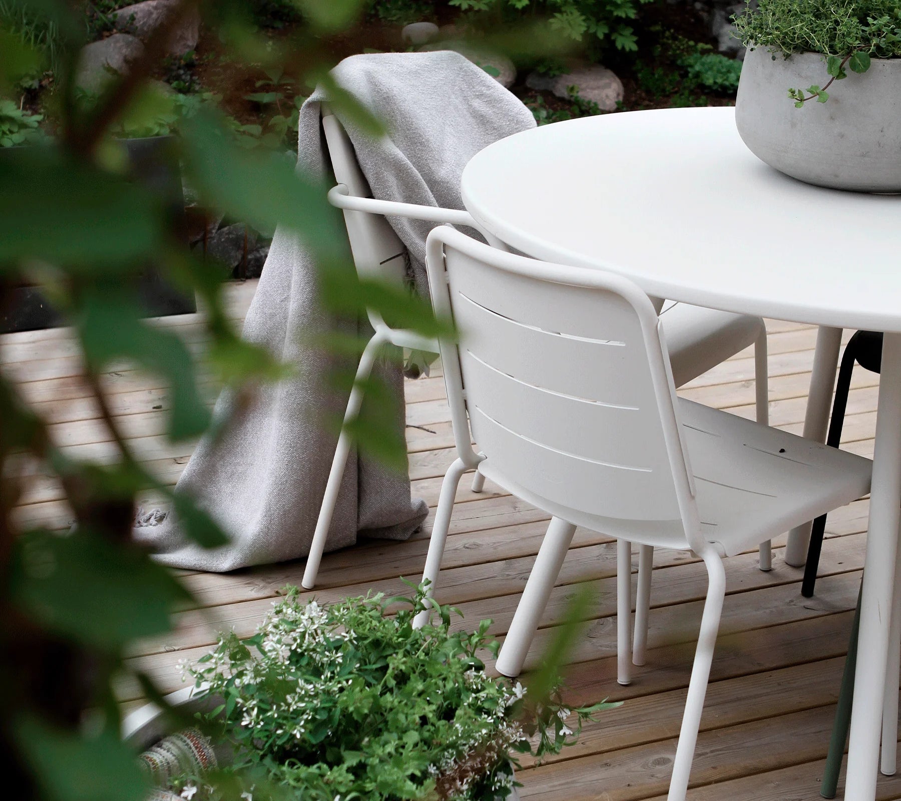 Boxhill's Area Outdoor Aluminum Dining Table White Lifestyle image on wooden platform