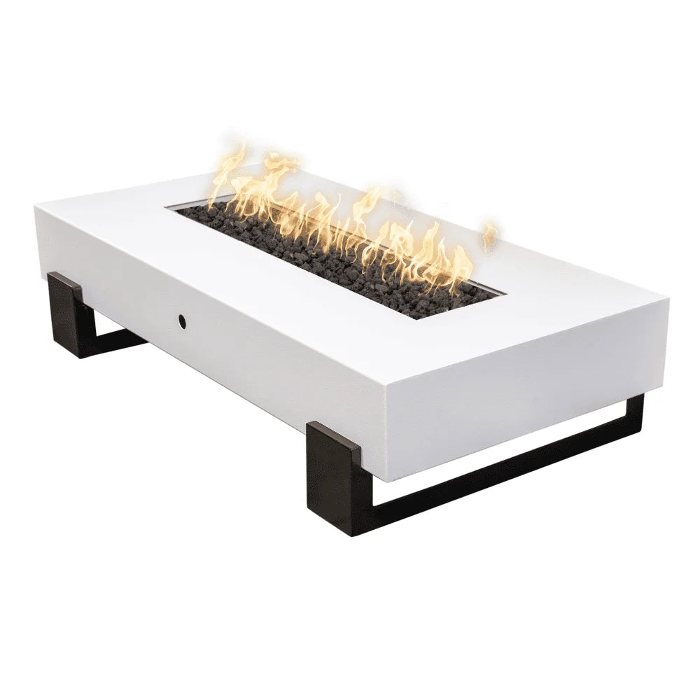 White outdoor rectangular powder coated metal fire pit table with black legs filled with lava rocks and fames on top