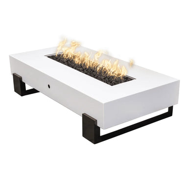 White outdoor rectangular powder coated metal fire pit table with black legs filled with lava rocks and fames on top