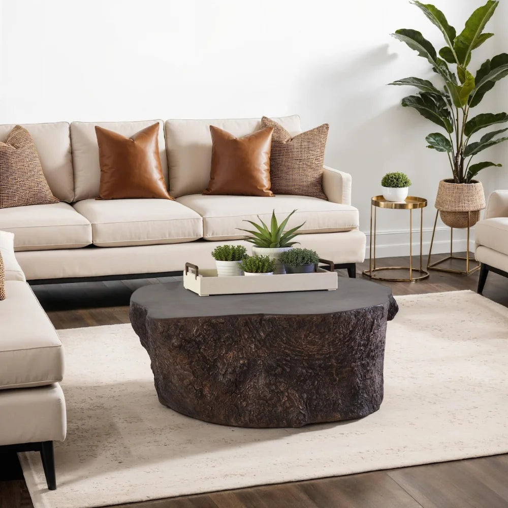 Bark Bronze Coffee Table holding a tray of plants in front of a cream sofa with warm brown pillows.