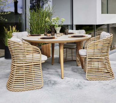 Boxhill's Basket Outdoor Dining Chair Natural lifestyle image with Aspect Teak Round Dining Table