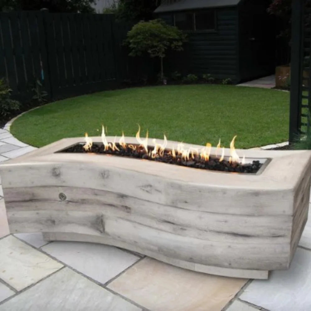 A light gray wood grain outdoor fire pit with sleek design placed on a tiled surface on an outdoor patio garden