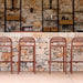 Four Aluminum outdoor bar chairs in front of an outdoor bar with stone-like concrete design