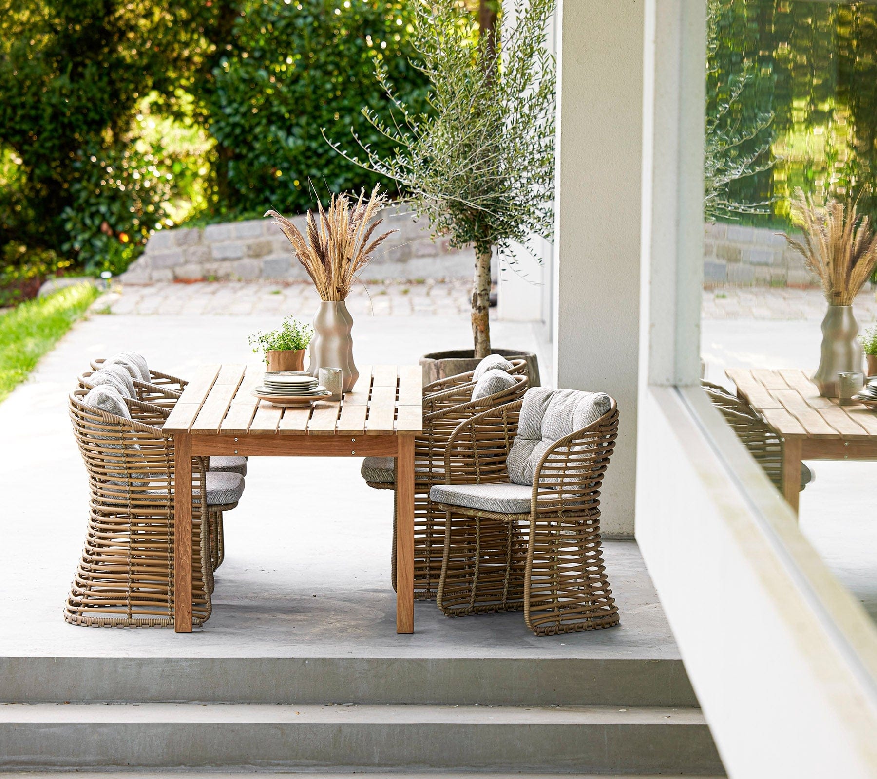 Boxhill's Basket Outdoor Dining Chair Natural lifestyle image with dining table