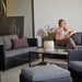 Boxhill's Diamond 2-Seater Weave Sofa lifestyle image with Diamond 3-Seater Weave Sofa and Diamond Weave Footstool with a woman sitting down at patio