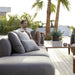 Boxhill's Capture Outdoor Corner Sofa w/ Table, Pouf, & Chaise lifestyle image with man sitting down