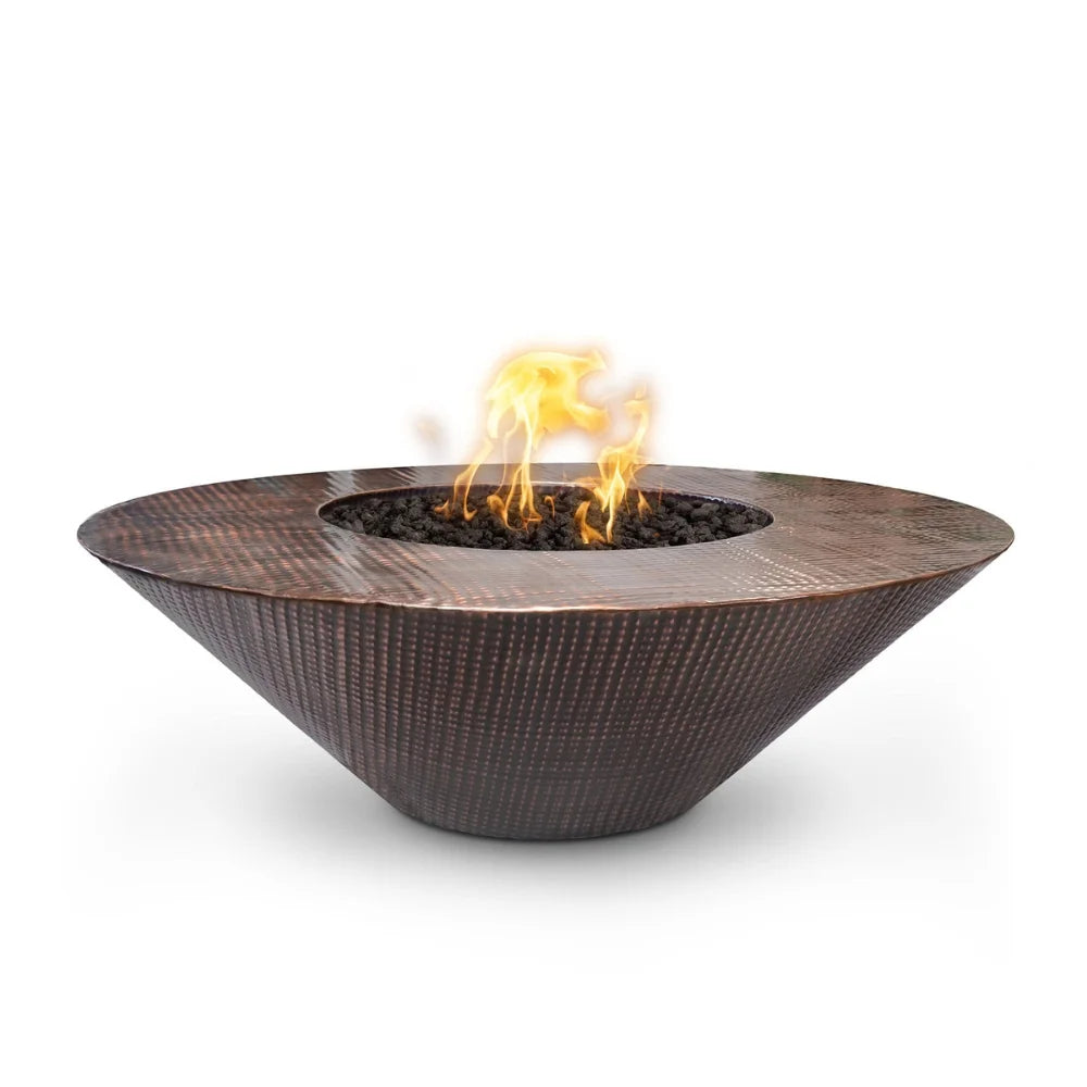 Brown tapered shaped Hammered copper round fire pits with flames over lava rocks