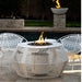 A white outdoor metal powdered coated fire pit table set on a patio beside the pool accompanied by two white metal chairs
