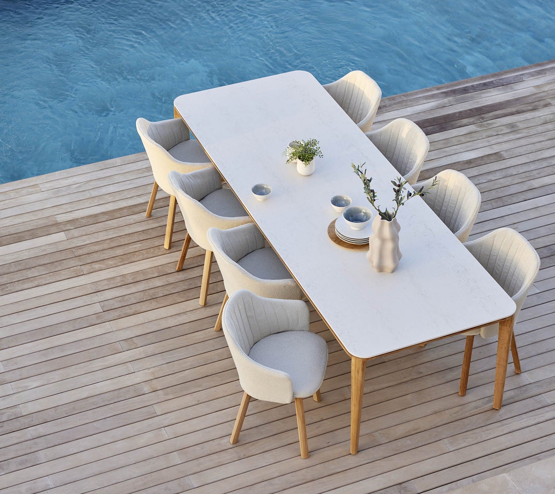 Boxhill's Choice Outdoor Dining Chair Teak Legs lifestyle image with Aspect Dining Table beside the pool