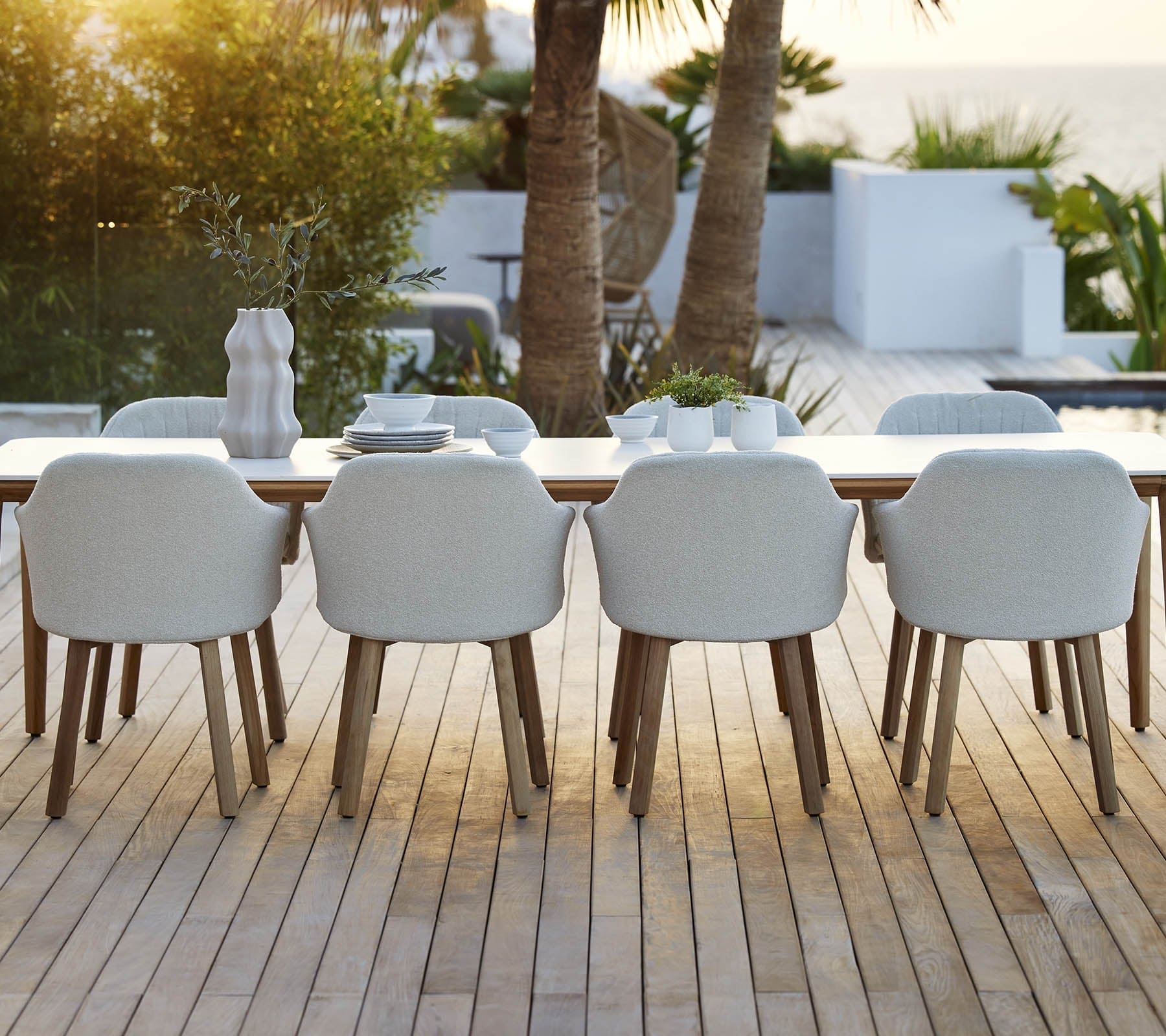 Boxhill's Choice Outdoor Dining Chair Teak Legs lifestyle image with Aspect Dining Table on wooden platform