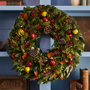 Decorative wreath with fruits and leaves on a blue background