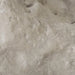 Close-up of the Colossal Cast Stone Single-Hole Sculpture’s pale, rugged surface with pits and sculpted contours.