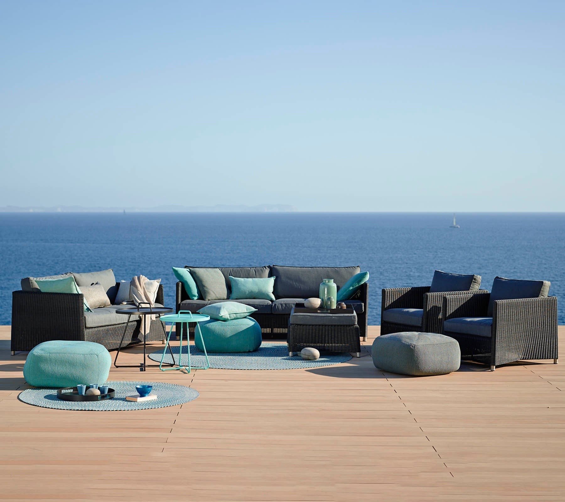 Boxhill's Diamond 3-Seater Weave Sofa lifestyle image with other Diamond Sofa collection on wooden platform at seafront