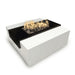 Black and white square metal powdered coated fire pit table with flames burning over lava rocks