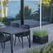 Boxhill's Grow Umbrella Base and Planter Box with Wheels lifestyle image beside dining table and dining chairs at patio