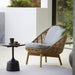 Boxhill's Glaze Outdoor Round Coffee Table lifestyle image with Hive Outdoor Lounge Chair at patio