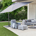 Boxhill's Hyde Luxe Tilt Aluminum Parasol | 3x3 m lifestyle image with 3-seater sofa, lounge chair and footstool at patio