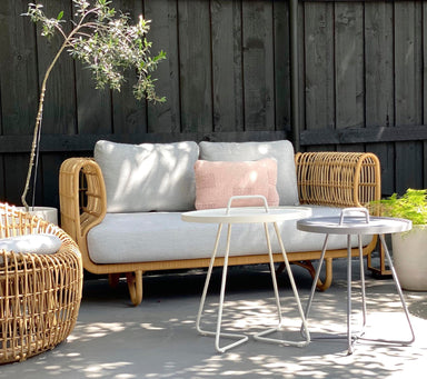 Boxhill's Nest 2-Seater Sofa lifestyle image with Nest Round Rattan Chair and 2 small round table at patio