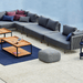 Boxhill's Moments 2-Seater Right Module Sofa lifestyle image beside the pool with other Moments Module Sofa Collection, 2 Level Coffee Table with Teak Top and a fabric footstool