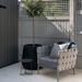 Boxhill's Conic Lounge Chair Light Grey lifestyle image at patio beside a plant