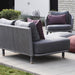 Boxhill's Moments 2-Seater Left Module Sofa lifestyle image with Moments Outdoor Lounge Chair and 2 fabric footstool at patio