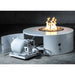 White round outdoor metal powdered coated fire pit with hidden propane tank placed on a concrete floor
