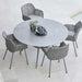 Boxhill's Joy Round Outdoor Dining Table Lifestyle image with 4 dining chairs at poolside