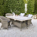 Boxhill's Lansing Outdoor Lounge Chair Taupe lifestyle image with Lansing Outdoor Rectangular Dining Table at patio