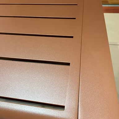 Close-up view of brown outdoor picnic table close-up, focusing on the tabletop surface
