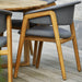 Boxhill's Luna Outdoor Dining Armchair Lifestyle image with teak round table close up view
