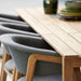 Boxhill's Luna Outdoor Dining Armchair Lifestyle image with teak dining table close up view